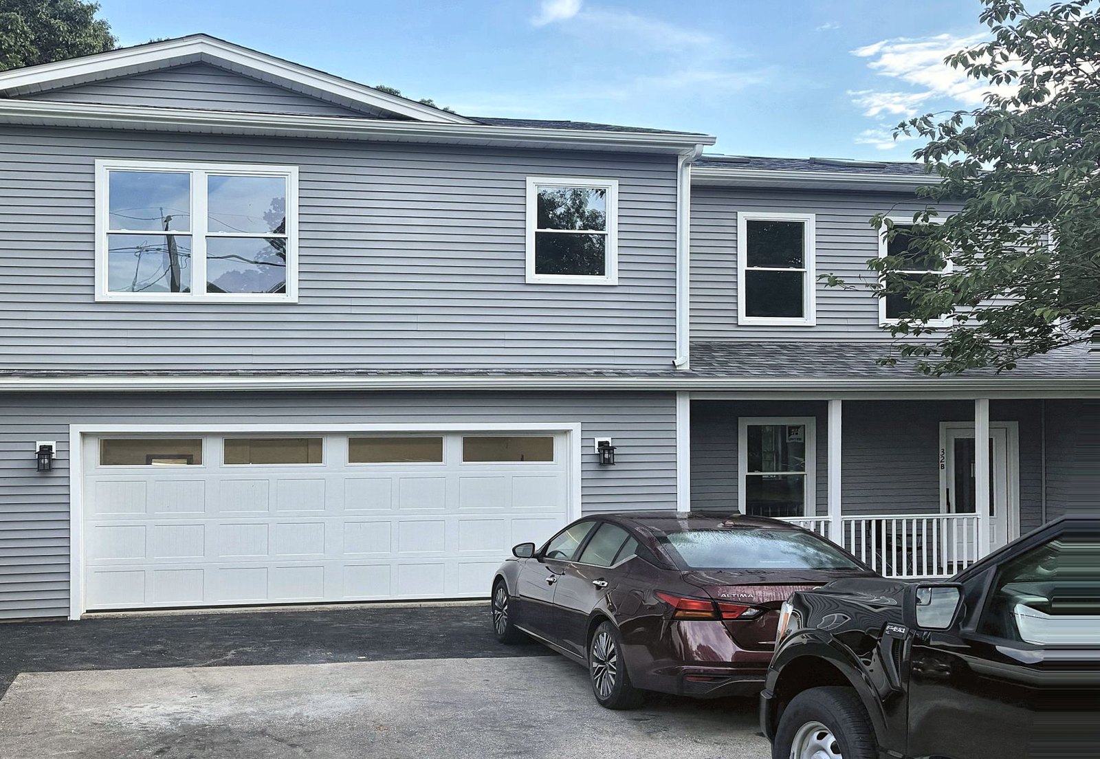 Front elevation — the ADU occupies the second story over the existing two-car garage